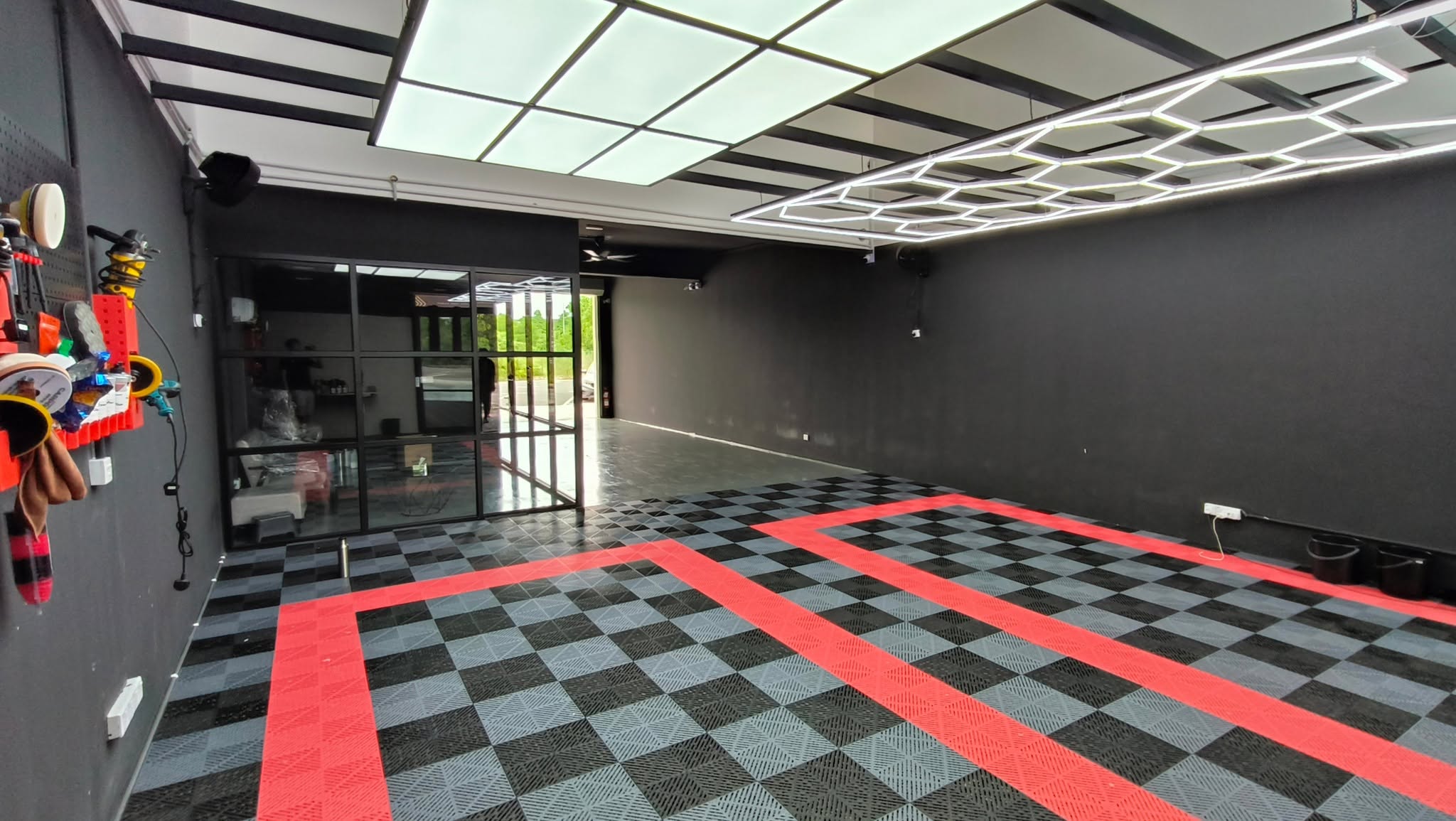 Workshop interior with glass partition and tool wall