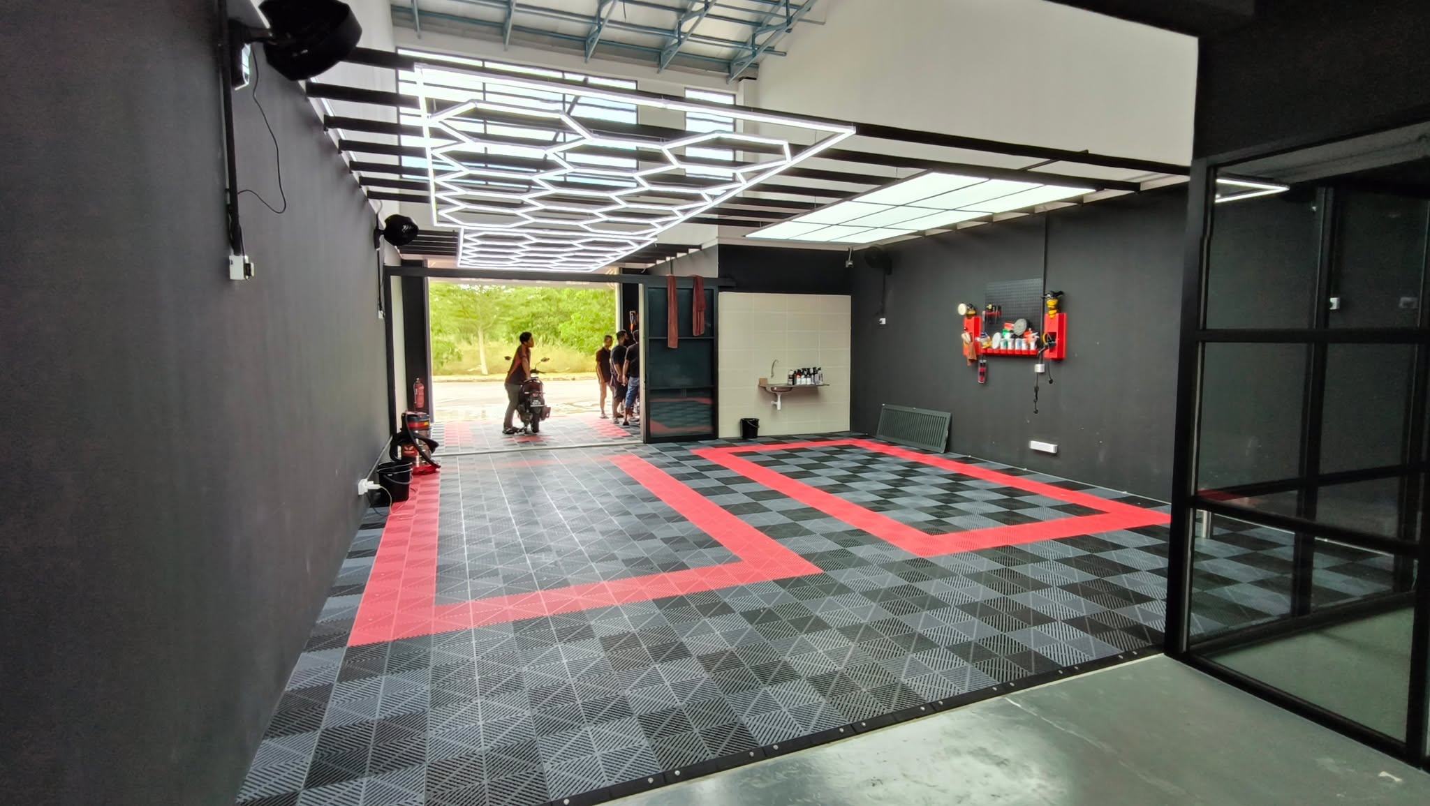 Completed car workshop renovation with dramatic hex ceiling lights