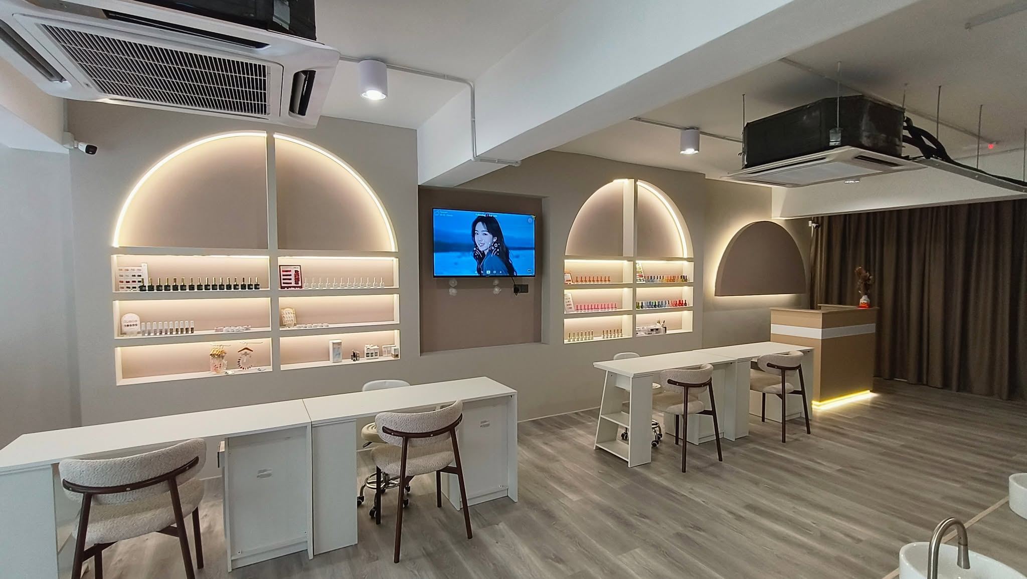 Completed nail salon interior design with arched lit shelves